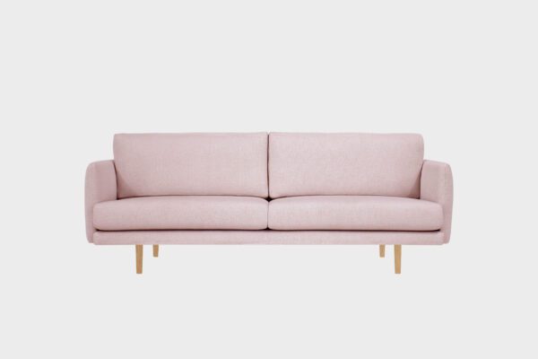 Kataja-kolmen istuttava sohva vaaleanpunaisella villabukleekankaalla verhoiltuna ja tammen sävyisillä puujaloilla, tuotekuva.