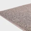 Harmaa VM Carpet Tweed matto. Lähikuva maton kulmasta, josta näkyy kanttaus ja maton materiaali.